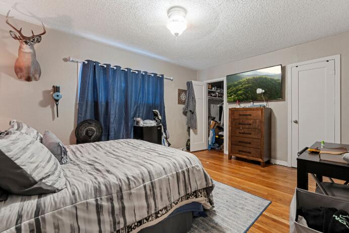 3004 33rd Street Lubbock, TX 79410 - Photo 6 of 10 a bedroom with a bed and a dresser