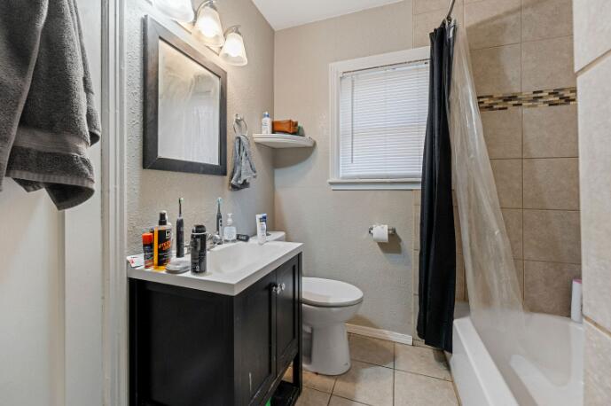 3004 33rd Street Lubbock, TX 79410 - Photo 8 of 10 a bathroom with a sink toilet and shower