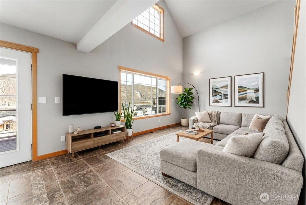 585 Entiat Place Orondo, WA 98843 - Photo 12 of 40 a living room with furniture a flat screen tv and a large window