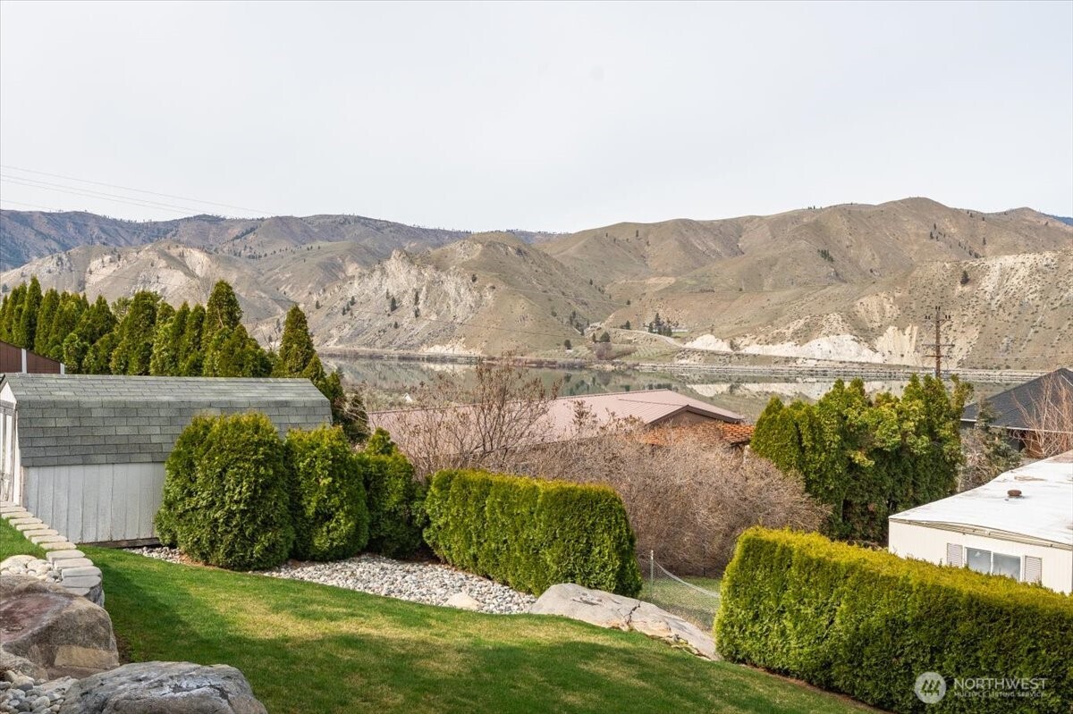 585 Entiat Place Orondo, WA 98843 - Photo 33 of 40 a view of a grassy area with mountains and a houses