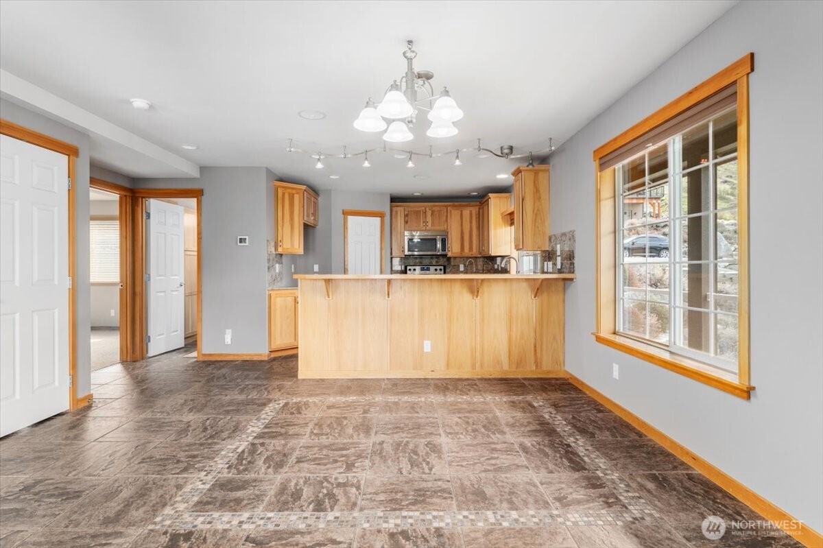 585 Entiat Place Orondo, WA 98843 - Photo 6 of 40 a view of a kitchen with wooden floor and a window