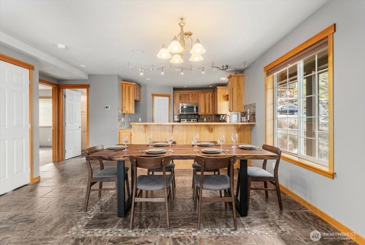 585 Entiat Place Orondo, WA 98843 - Photo 7 of 40 a view of a dining room with furniture window and wooden floor