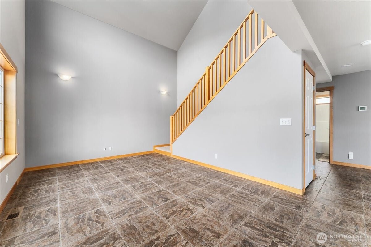 585 Entiat Place Orondo, WA 98843 - Photo 10 of 40 a view of an empty room with wooden floor and stairs
