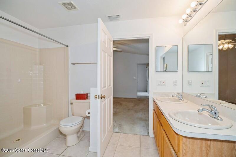 570 Benton Drive Melbourne, FL 32901 - Photo 14 of 26 a bathroom with a sink a toilet and shower