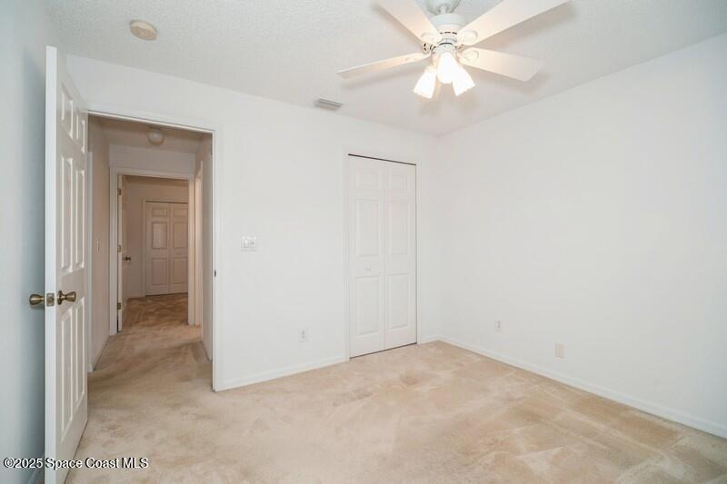 570 Benton Drive Melbourne, FL 32901 - Photo 18 of 26 an empty room with a ceiling fan and a window