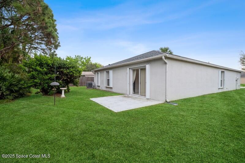570 Benton Drive Melbourne, FL 32901 - Photo 21 of 26 a backyard of a house with plants and large tree