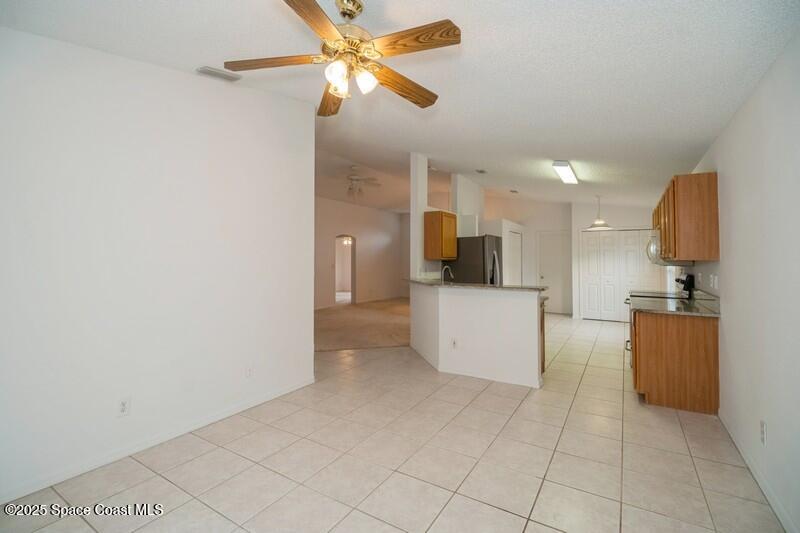 570 Benton Drive Melbourne, FL 32901 - Photo 10 of 26 a view of a kitchen with a sink and a refrigerator