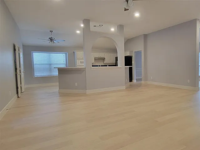 a view of kitchen with cabinets and wooden floor