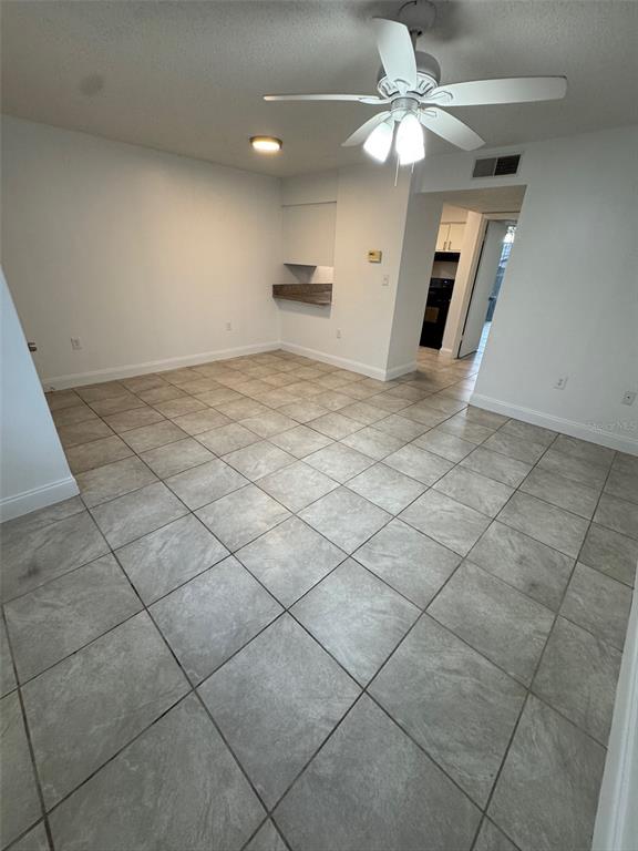 1185 Bentley Road, Unit 3 Leesburg, FL 34748 - Photo 5 of 11 an empty room with windows and ceiling fan