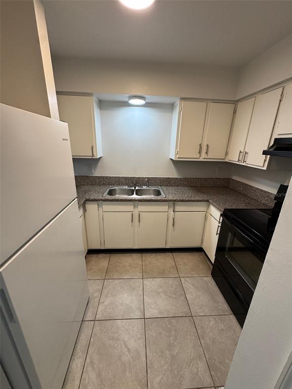 1185 Bentley Road, Unit 3 Leesburg, FL 34748 - Photo 6 of 11 a kitchen with granite countertop a sink a stove and cabinets