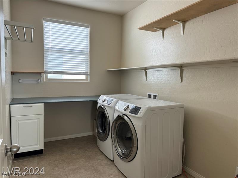 9056 Tony Ridge Avenue Las Vegas, NV 89148 - Photo 26 of 32 A well-appointed utility room featuring a practical counter space and convenient shelving.