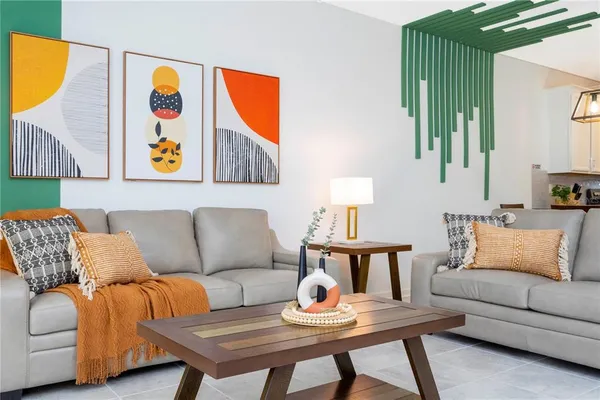 a living room with furniture and a painting on the wall
