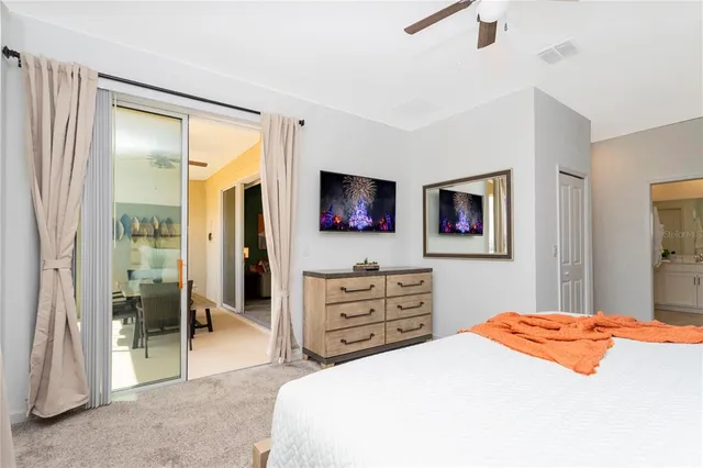 a bathroom with a granite countertop sink a toilet a shower and a mirror