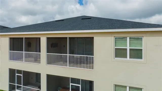 a view of a brick house with a yard and plants