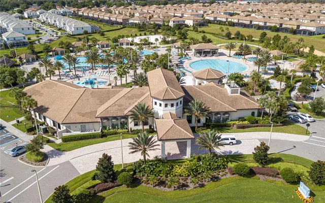 an aerial view of residential houses with outdoor space and swimming pool