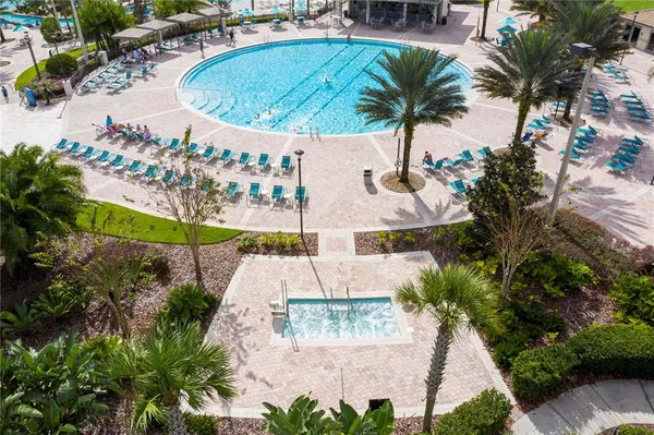 an aerial view of residential houses with outdoor space and swimming pool