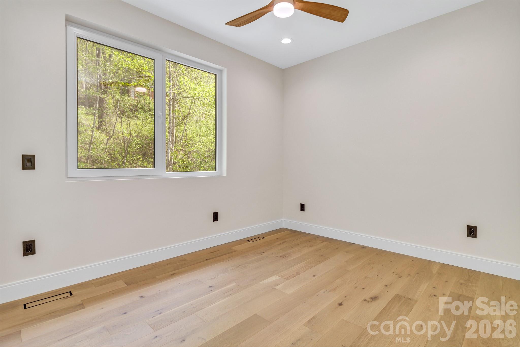 134 View Ridge Parkway Leicester, NC 28748 - Photo 36 of 48 a view of an empty room with wooden floor and a window
