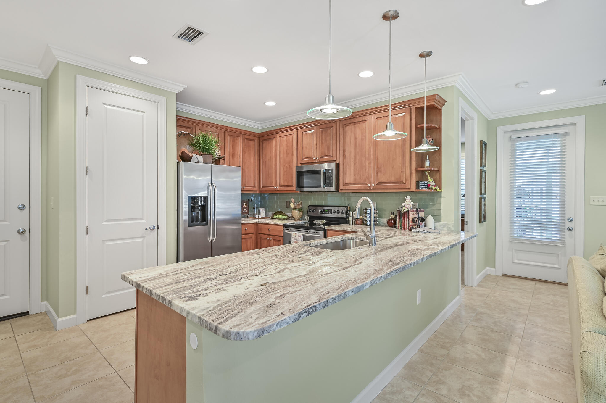 100 South Zander Way Santa Rosa Beach, FL 32459 - Photo 8 of 40 a large kitchen with kitchen island a large counter top stainless steel appliances and cabinets