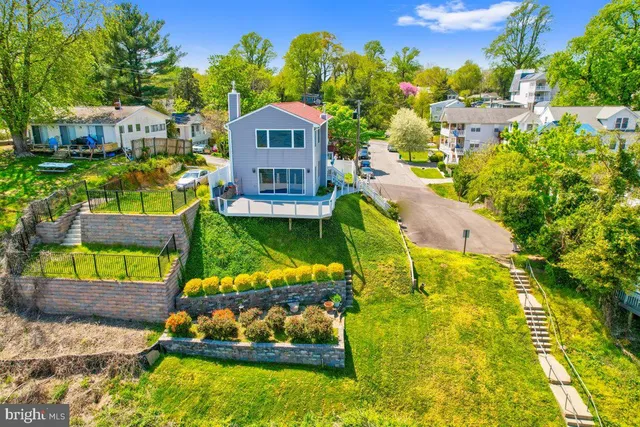 a view of a house with a yard and potted plants