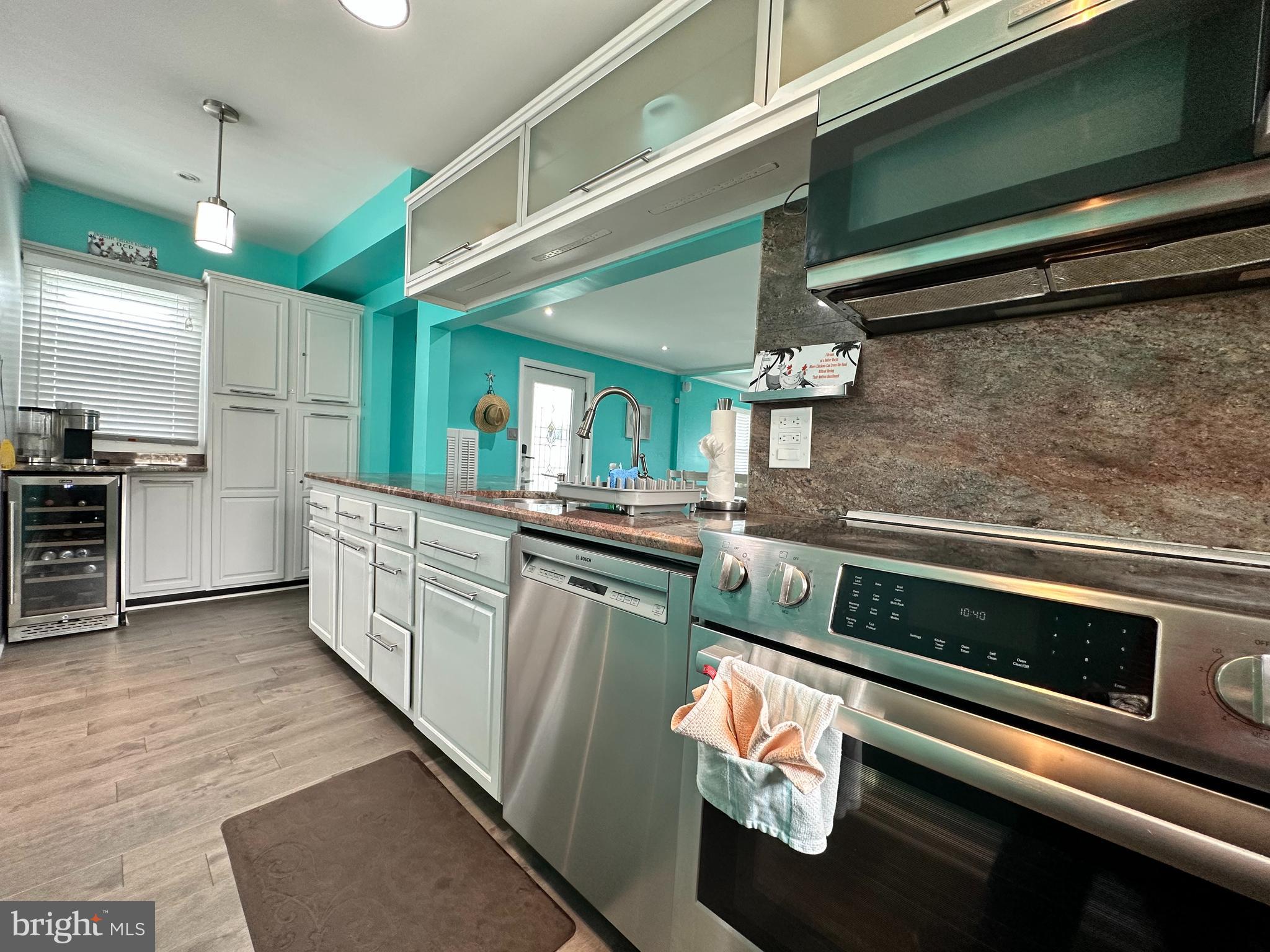 7517 B Street Chesapeake Beach, MD 20732 - Photo 46 of 78 a kitchen with stainless steel appliances granite countertop a stove a sink and a refrigerator
