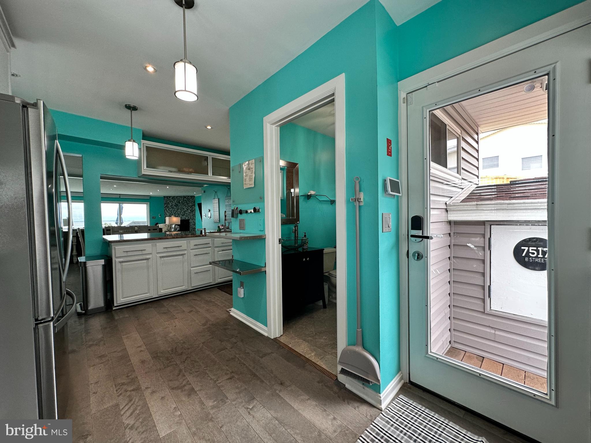 7517 B Street Chesapeake Beach, MD 20732 - Photo 48 of 78 a kitchen with stainless steel appliances kitchen island granite countertop a refrigerator and a stove
