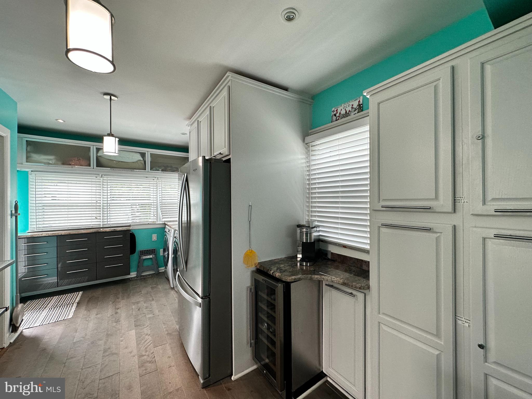 7517 B Street Chesapeake Beach, MD 20732 - Photo 54 of 78 a kitchen with a refrigerator and white cabinets