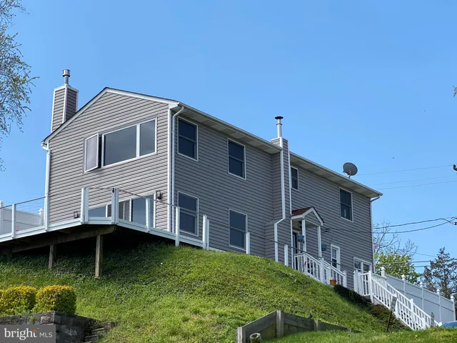 an aerial view of a house with a garden and swimming pool