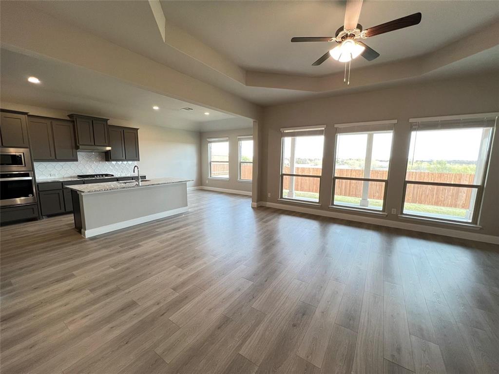 3611 Walnut Rdg Drive Midlothian, TX 76065 - Photo 11 of 29 a large kitchen with stainless steel appliances granite countertop a dishwasher kitchen island a stove and a wooden floors