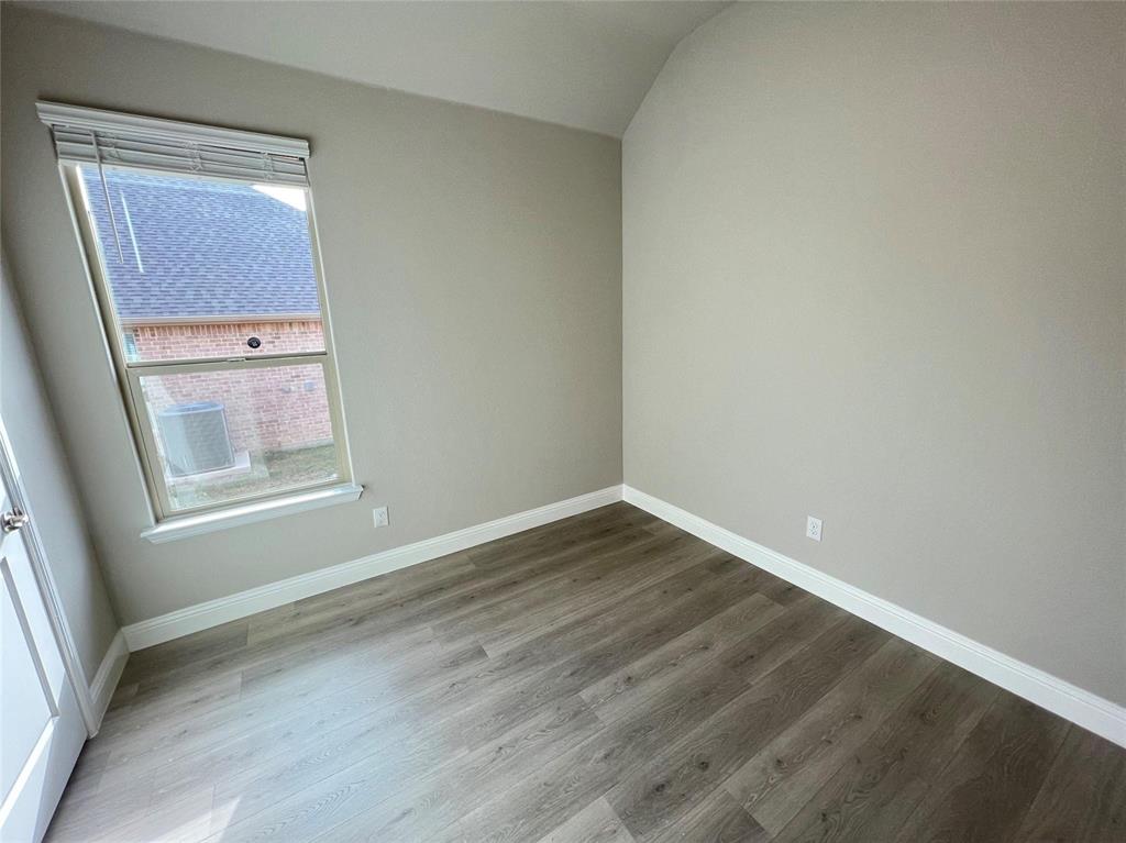 3611 Walnut Rdg Drive Midlothian, TX 76065 - Photo 21 of 29 a view of an empty room with wooden floor and a window