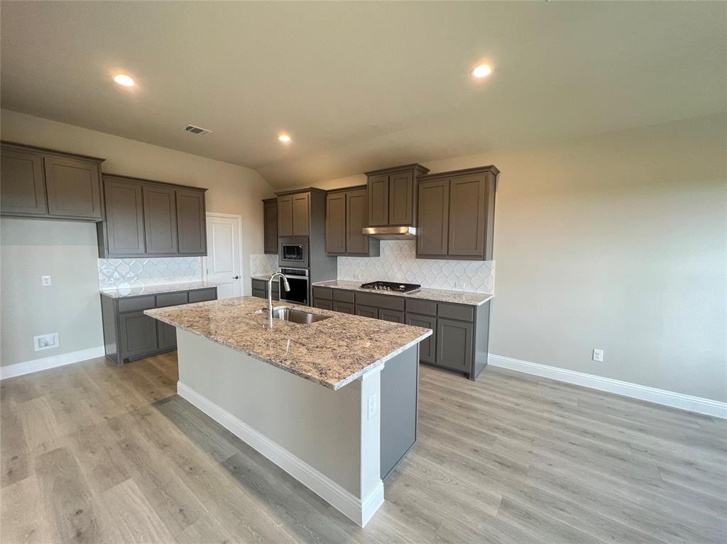 3611 Walnut Rdg Drive Midlothian, TX 76065 - Photo 6 of 29 a kitchen with a sink cabinets and wooden floor