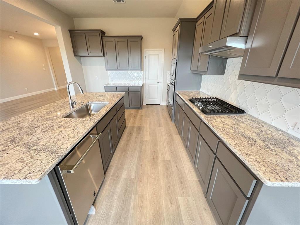 3611 Walnut Rdg Drive Midlothian, TX 76065 - Photo 7 of 29 a kitchen with granite countertop a sink stove and cabinets