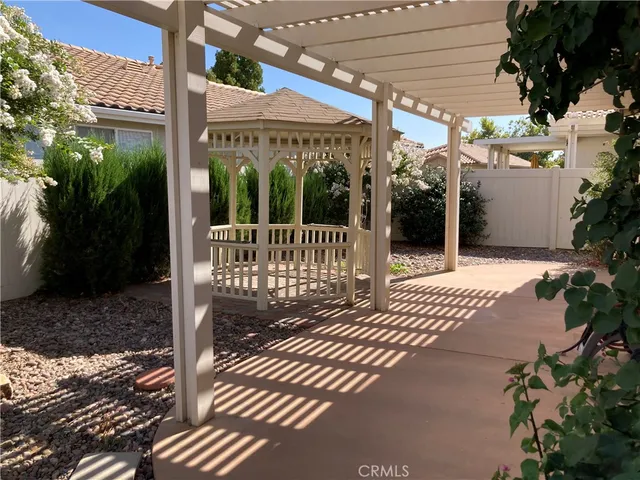 a view of a patio with a table and chairs
