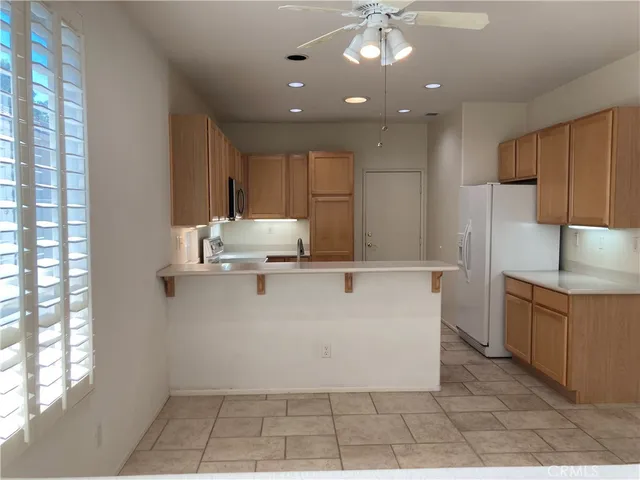 a view of kitchen with stainless steel appliances granite countertop a refrigerator and a sink