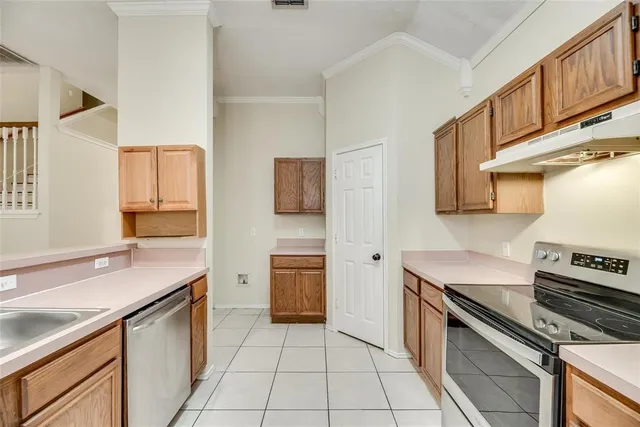 a kitchen with a sink appliances and cabinets