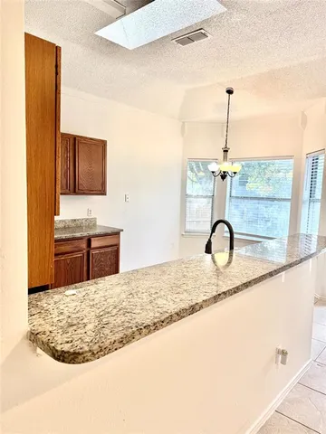 a kitchen with a granite countertop sink and a granite counter tops