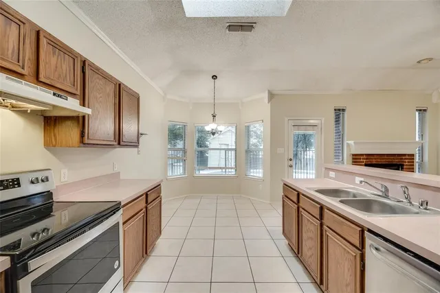 a kitchen with stainless steel appliances granite countertop a sink stove and cabinets