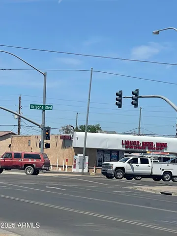 a view of a city street with a car parked on the road