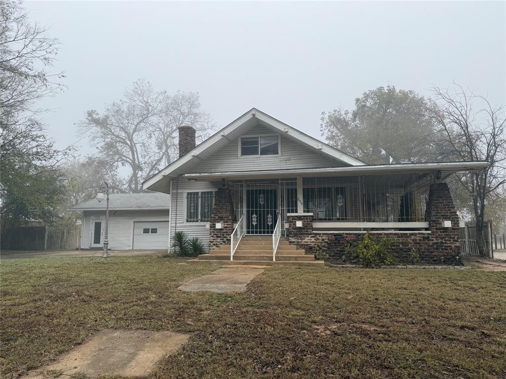 215 West Sears Street Denison, TX 75020 - Photo 1 of 1 a front view of a house with garden