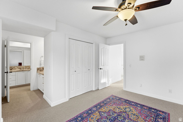 1878 East Ridge Point Drive Bountiful, UT 84010 - Photo 38 of 92 Unfurnished bedroom featuring light carpet, a ceiling fan, and a closet