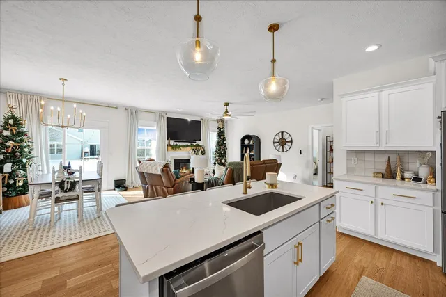 a kitchen that has a lot of cabinets a sink and appliances in it
