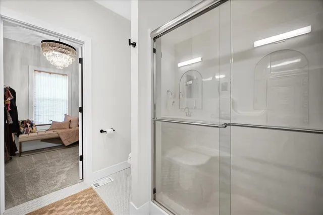 a bathroom with a glass shower door