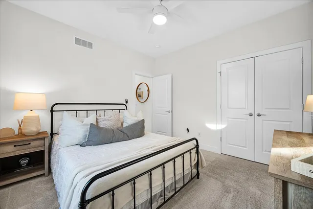 a bedroom with a bed and a lamp