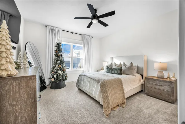 a bedroom with bed and a chandelier