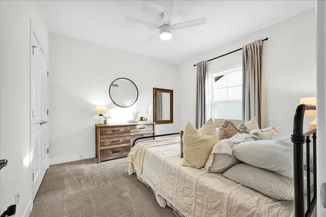 a bed room with a bed mirror and a window