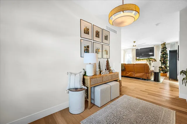 a living room with furniture and kitchen view