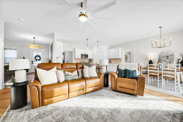 a living room with furniture a dining table and chairs with kitchen view