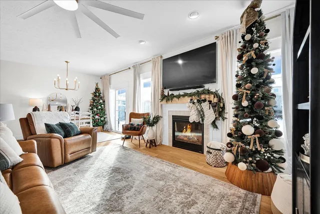 a living room with furniture a flat screen tv and a fireplace
