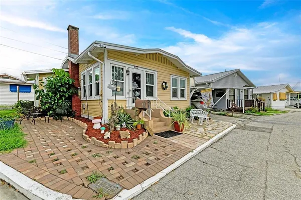 a front view of a house with sitting area