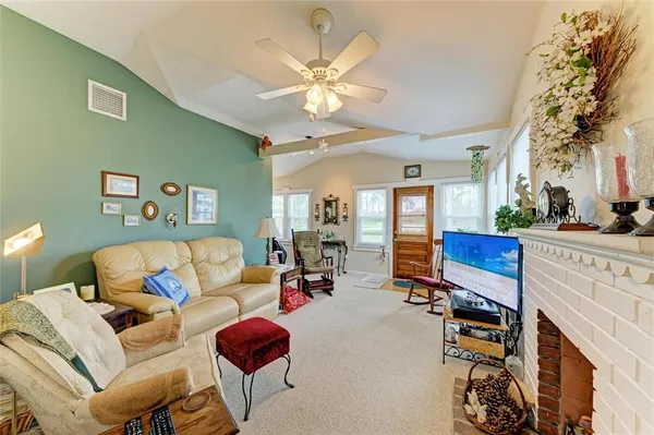 a living room with furniture a rug and a fireplace