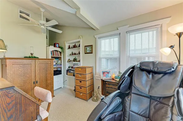 a view of a bedroom with furniture and a window